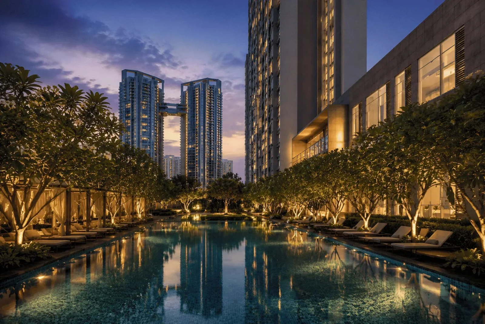Resort pool at dusk with the towers beyond